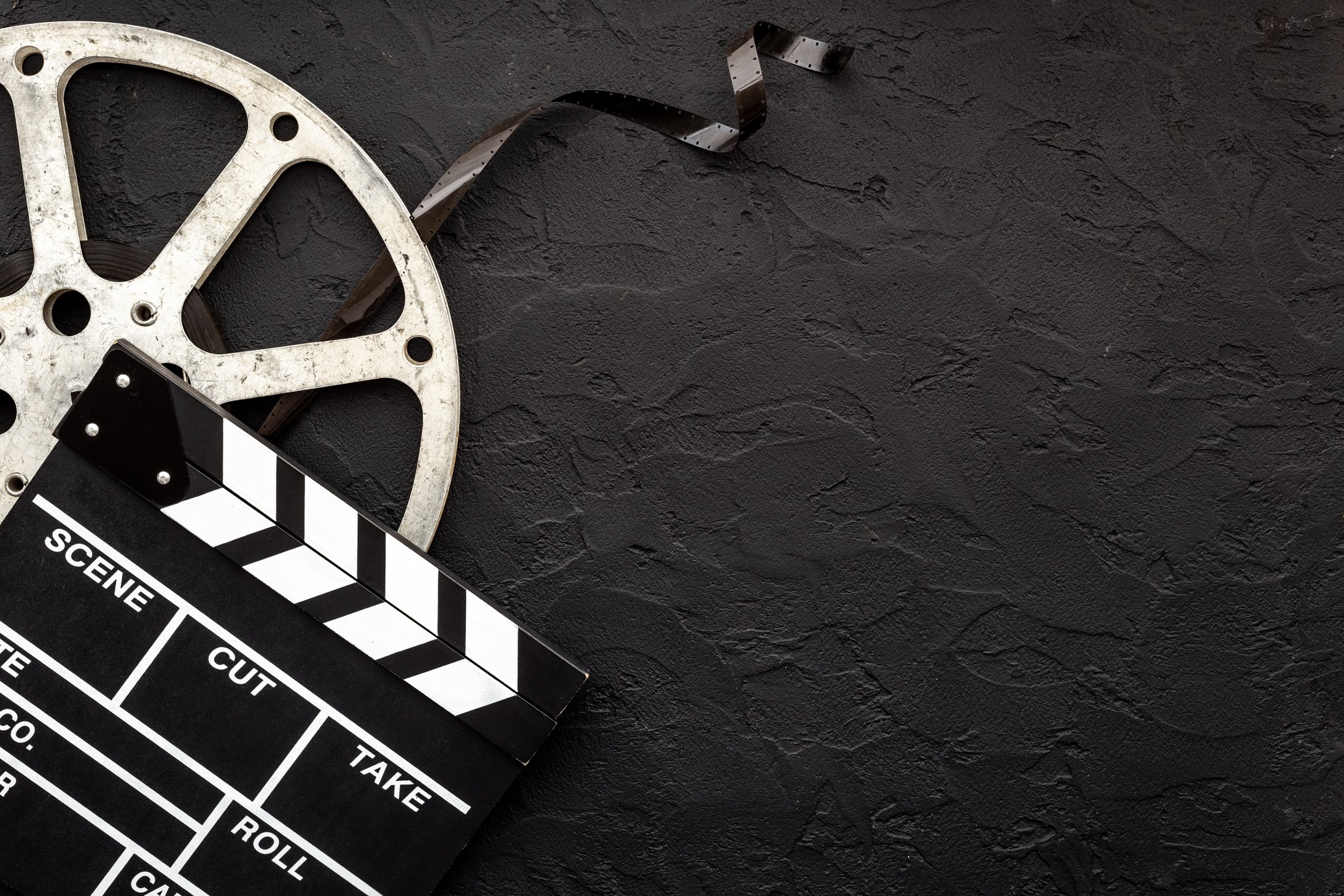 Movie film reel with clapperboard. Cinema concept